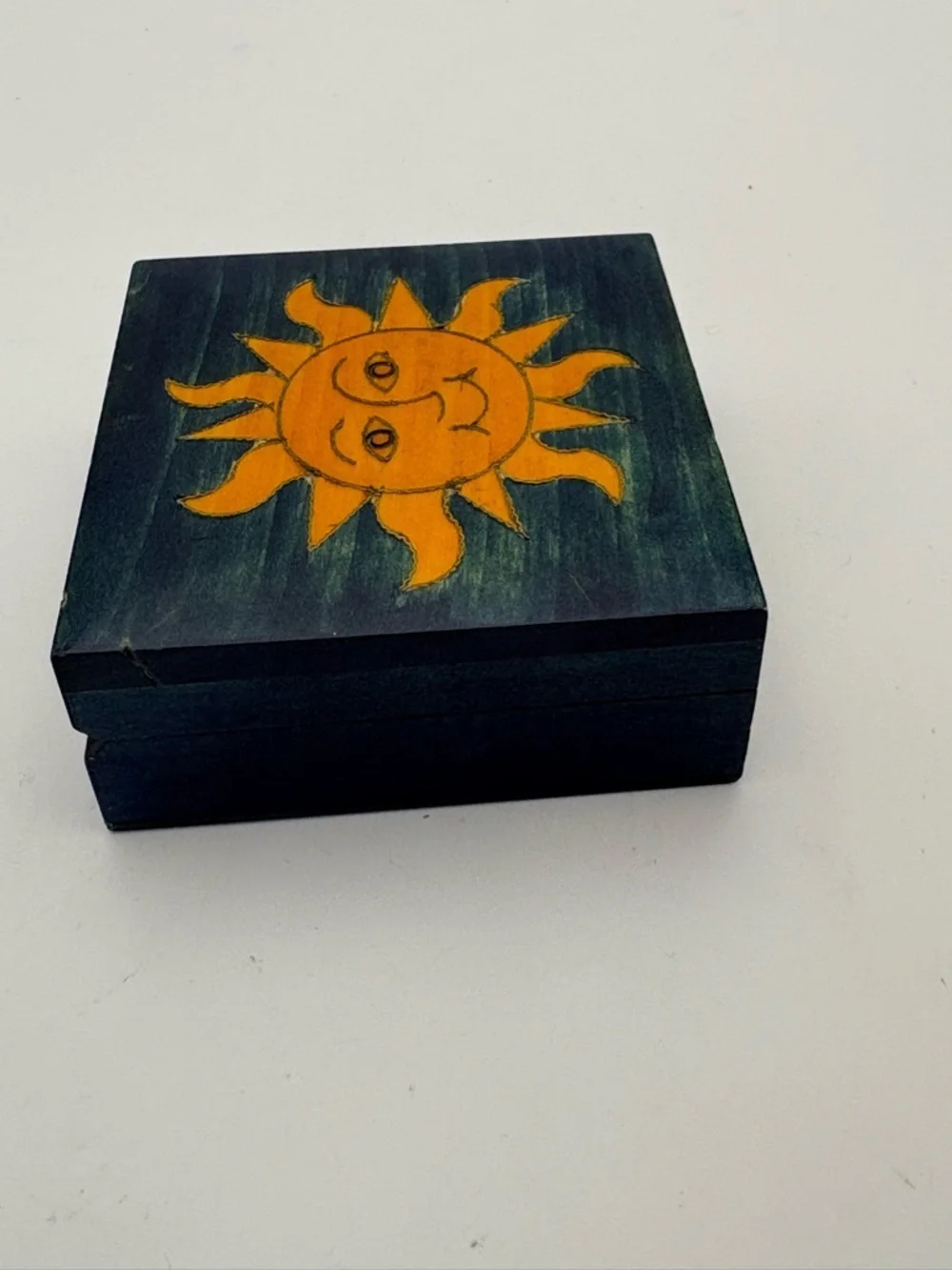 Bright Yellow Sun on Deep Blue Wooden Box